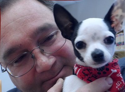 Dr. Christmann holding a small white and black puppy